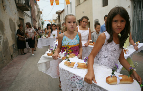 Parelles d'infants precedeixen la cercavila del Pa Beneït